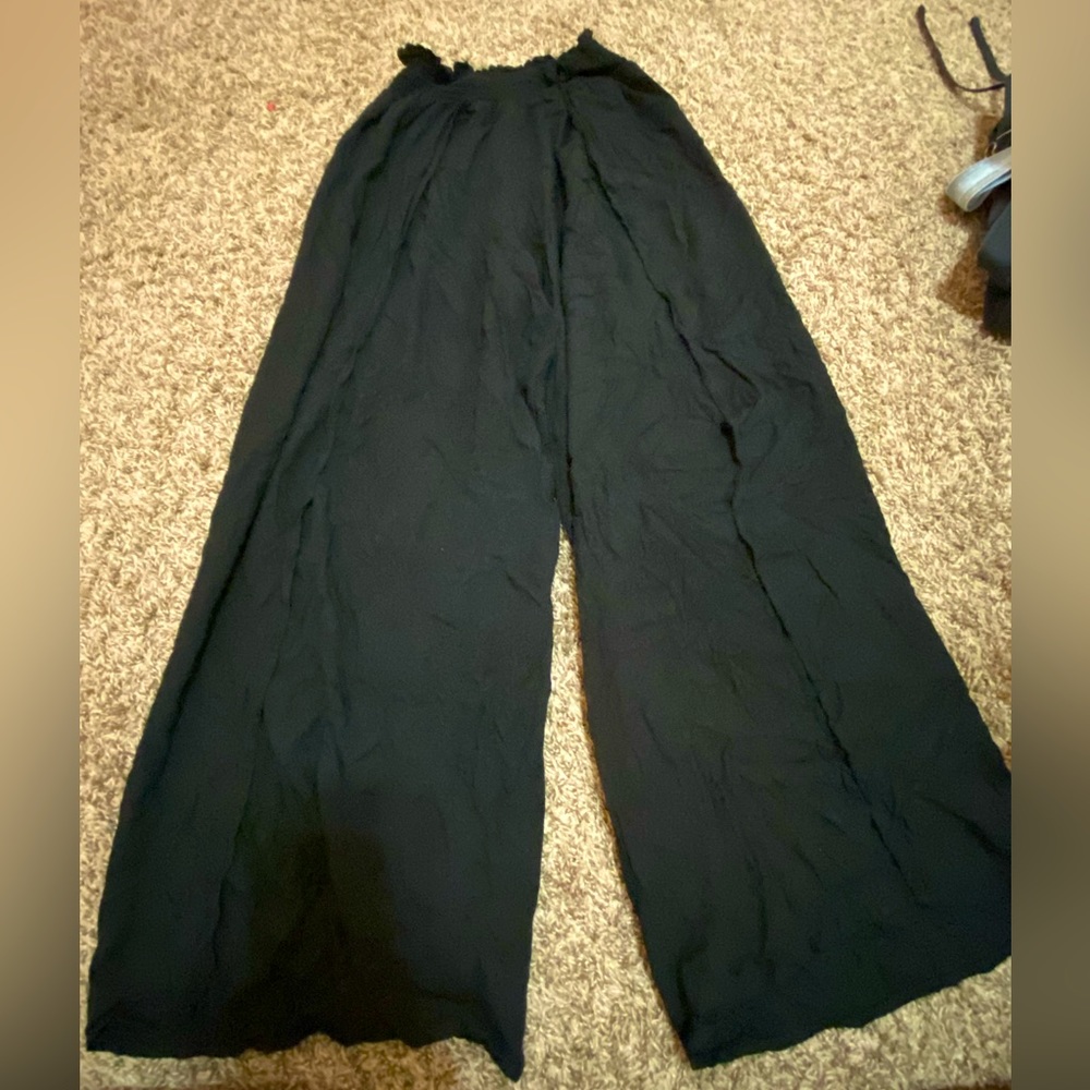 black flowy pants with elastic band and slits up the legs